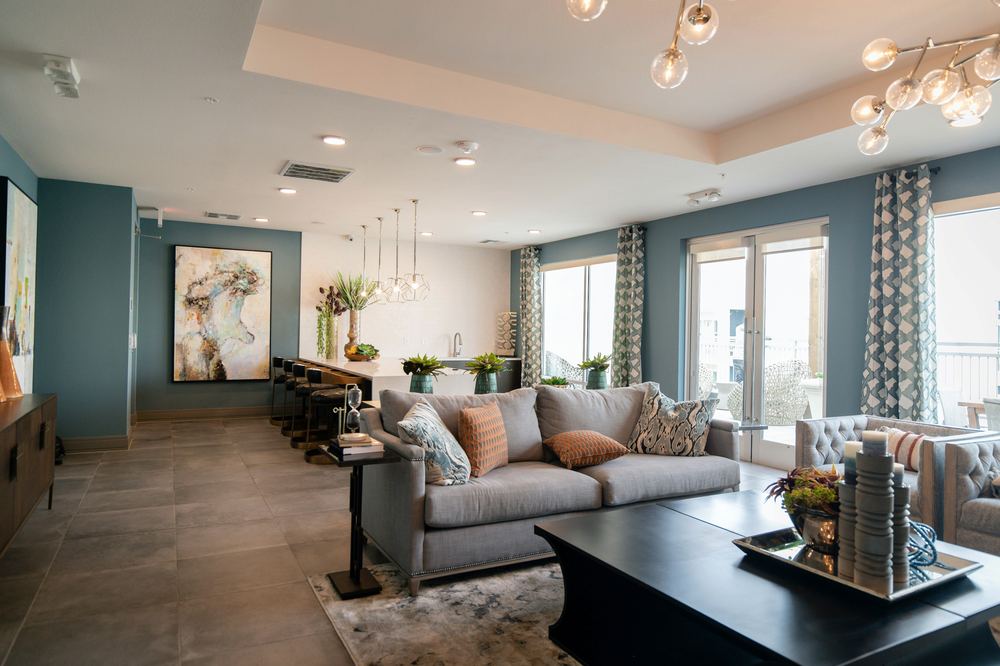 Whole home remodel living area in Houston, TX with open-concept layout, statement lighting, and custom paint